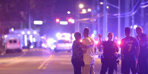 Police officers direct people away from the nightclub in Orlando,Florida,