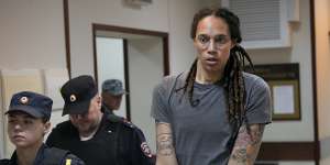 WNBA star and two-time Olympic gold medallist Brittney Griner is escorted from a courtroom.