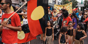 Protesters march through Redfern on Australia Day to protest celebrating on January 26.