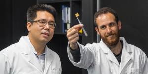 Dongchen Qi (left) with QUT student David Sommers and one of the team's diamond circuits.