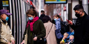 People wearing masks in Sydney’s CBD. From Wednesday,people in NSW,Queensland and South Australia won’t have to wear masks on public transport. 