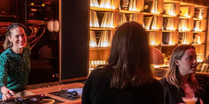 Her Music Room is one of several new vinyl-focused bars in Melbourne,where DJs like JNett (pictured) get to play behind the bar.