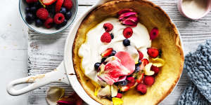 Dutch baby pancake dressed up with berries and rose petals. 