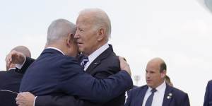 Prime Minister Benjamin Netanyahu embraces President Joe Biden after the US president arrived in Israel on October 18.