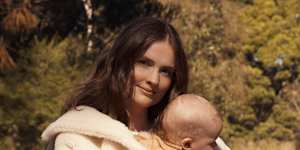 Laura Henshaw,with baby Atlas. Laura wears Max Mara coat. Zara dress and boots. Atlas wears Nature Baby (throughout).