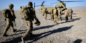 Australian troops from Special Operations Task Group and their Afghan counterparts from the Provincial Response Company walk to a CH-47 Chinook aircraft ahead of a mission.