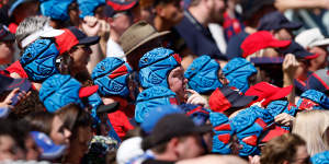 Melbourne fans wear helmets for Angus Brayshaw,who retired earlier this year due to the impact of concussion.