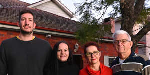 Claire Walker with partner Hugh and her parents outside their family home