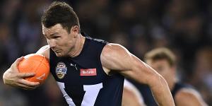 Patrick Dangerfield charges free of a tackle by the All-Stars'Michael Walters in Friday night's bushfire relief state-of-origin match at Marvel Stadium.