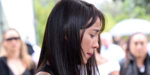 A mourner looks over Tara Brown's coffin.