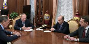 Russian President Vladimir Putin talks with Foreign Minister Sergey Lavrov,left,Federal Security Service head Alexander Bortnikov,second right,and Foreign Intelligence Service Sergei Naryshkin in 2016.