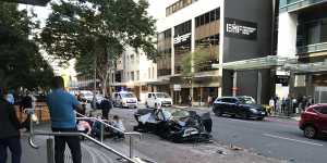 Three hospitalised after Tesla and ambulance crash in Brisbane CBD