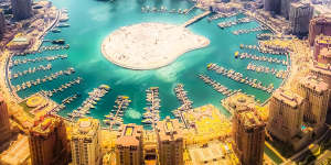 Doha city form the sky. The capital of the State of Qatar,located at the shore of the Persian Gulf. The Pearl is a purpose-built artificial island off the coast of Doha,connected to the mainland by a bridge. feb12coverÃÂ TRAVELLERÃÂ Middle East Moments byÃÂ BelindaÃÂ Jackson. Photo:iStock