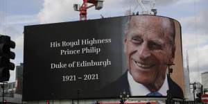 A tribute is projected onto a large screen at Piccadilly Circus in London.