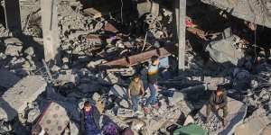 People inspect the damage to their homes following Israeli airstrikes on Rafah,Gaza.