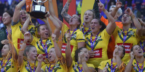 Australia’s players celebrate with the trophy after winning the World Cup.