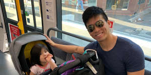 Josh Koh and daughter Arabelle ride the tram from Randwick to the city on Monday morning. 