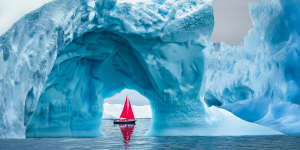 A boat saild past icebergs off Greenland.