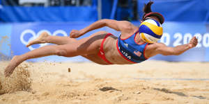 USA’s Sarah Sponcil #2 dives to return the ball against Latvia at the beach volleyball preliminaries on Monday.