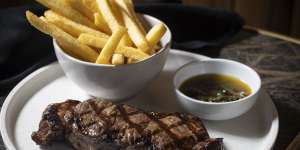 Porterhouse steak with chimichurri and chips.