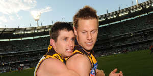 Shane Crawford and Sam Mitchell after Hawthorn’s famous 2008 premiership win.