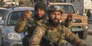 Syrian opposition fighters ride along the streets in the aftermath of the opposition’s takeover of Hama,Syria,on Friday.