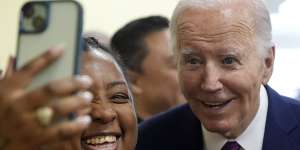 US President Joe Biden poses for a photo as he visits CJ’s Cafe in Los Angeles.