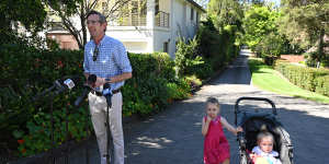 Dominic Perrottet with daughters Harriet and Beatrice outside their Beecroft home on Sunday.