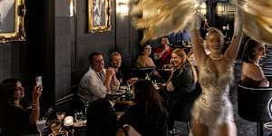 The room buzzes during the burlesque performance.