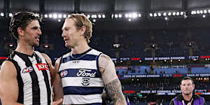 Scott Pendlebury of the Magpies and Tom Stewart of the Cats embrace after the final siren.