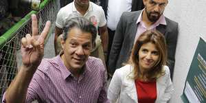 Workers'Party presidential candidate and wife Ana Estela arrive to cast their vote in Sao Paulo.