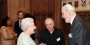 Queen Elizabeth II (L) speaks with British actor Christopher Lee in 2015.