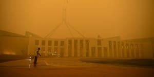 Parliament House in Canberra shrouded in eerie smoke.