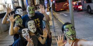 Demonstrators wearing face masks pose for a selfie photograph during the Face Mask Way event in the in Hong Kong.