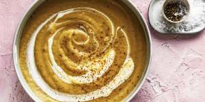 Parsnip and onion soup swirled with cream.