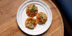 Crab and corn paapdi chaat are on the menu at Enter Via Laundry’s new bar.