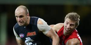 Chris Judd tries to escape the clutches of Sydney's Kieren Jack in round 17.