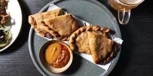Shaphaley (fried flatbread stuffed with chicken mince and cabbage) served with hot sauce.