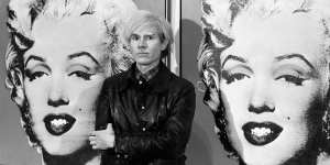 Andy Warhol in front of a double portrait of Marilyn Monroe at the Tate Gallery in 1971. 