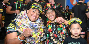 Panthers players Brian To’o and Jarome Luai celebrate their victory while wearing their candy leis.