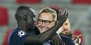 Awer Mabil celebrates with FC Midtjylland director Claus Steinlein after clinching UEFA Champions League qualification last month