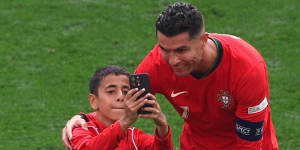 Ronaldo takes a selfie with a young fan.
