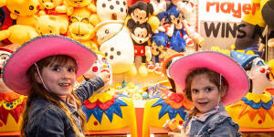 Chloe (left) and Olivia Alabakis try the amusements on offer at this year’s Melbourne Royal Show.