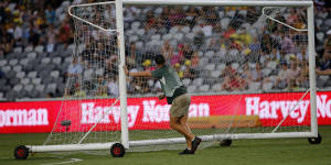 Offside:Workers wheel in a replacement goal after Tomislav Mrcela damaged the goalpost.