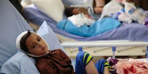 A child injured in a deadly Saudi-led coalition airstrike on on a school bus rests in a hospital in Saada,Yemen.