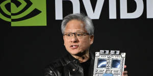 Jensen Huang holds up the