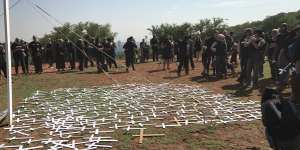 Protesters lay cross symbols on the ground during a demonstration by South African farmers and farm workers at the Voortrekker monument in Pretoria last October.