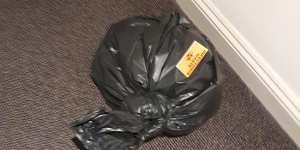 A bag left in a corridor at the Rydges on Swanston marked"infectious waste".