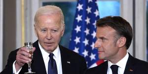 US President Joe Biden and French President Emmanuel Macron toast during a state dinner.