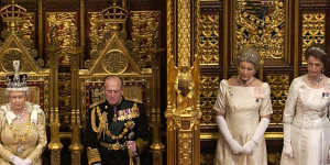 Queen Elizabeth,accompanied by Prince Philip and two ladies in waiting,opens Parliament in London